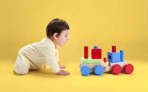Baby with Wooden Toy
